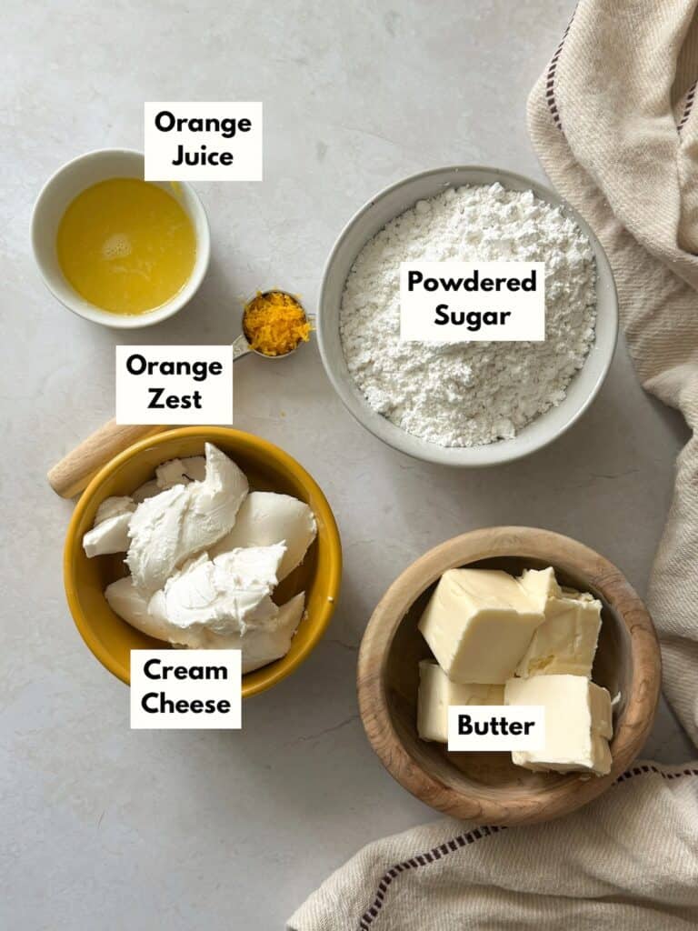 orange cream cheese frosting ingredients in individual cups and bowls.