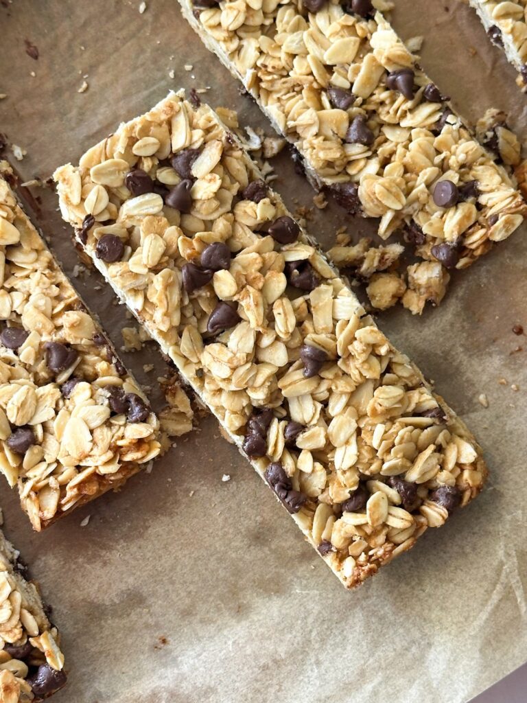 several sourdough granola bars in a line on parchment paper. 