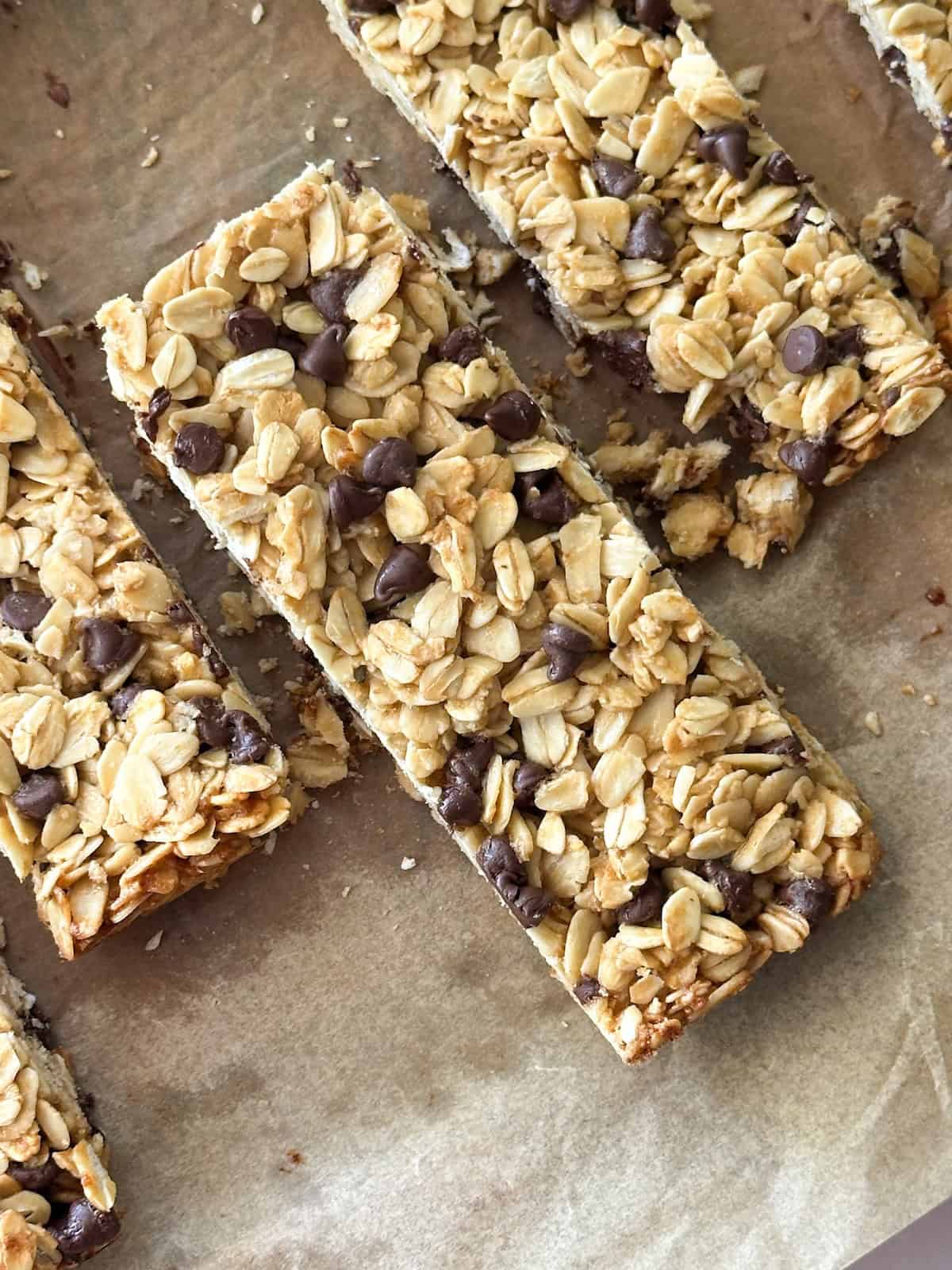 several sourdough granola bars in a line on parchment paper.