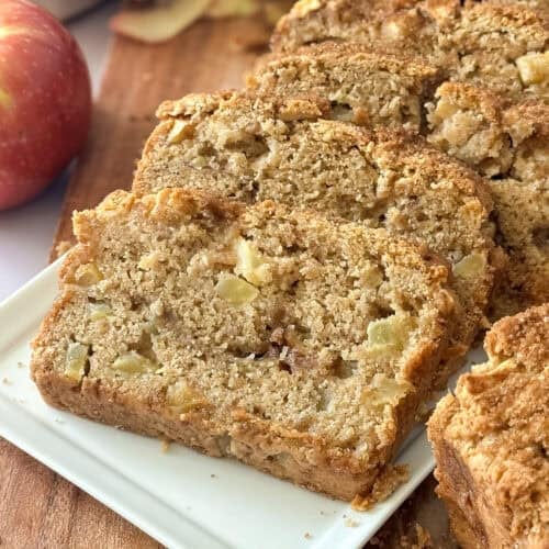 finished sourdough discard apple bread sliced on a serving plate.