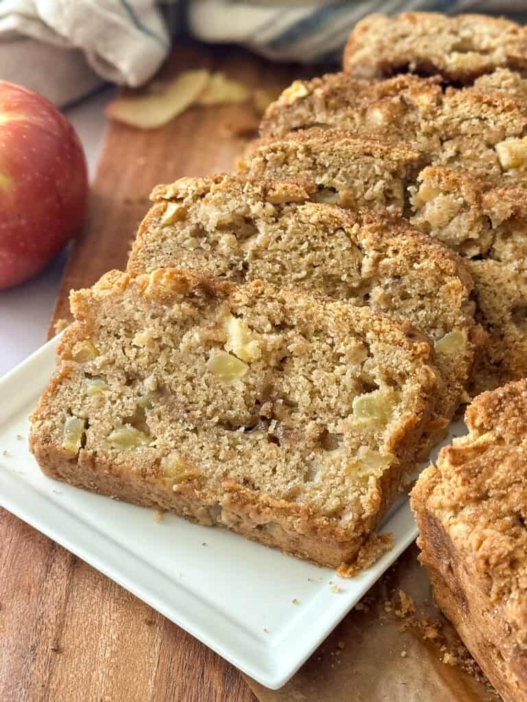 finished sourdough discard apple bread sliced on a serving plate.